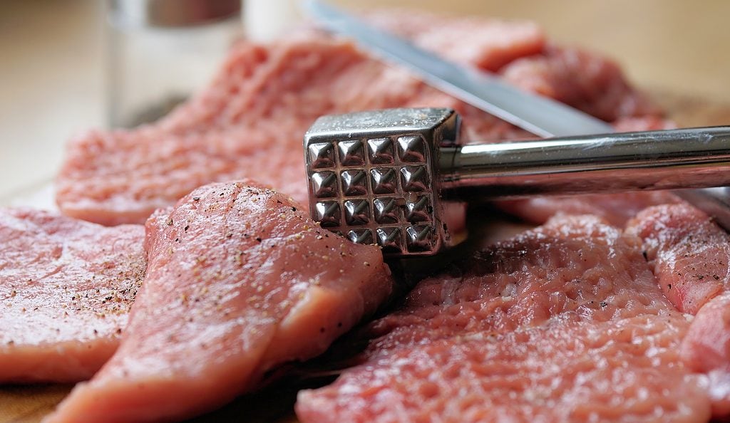 Beaten pork cutlets with meat hammer