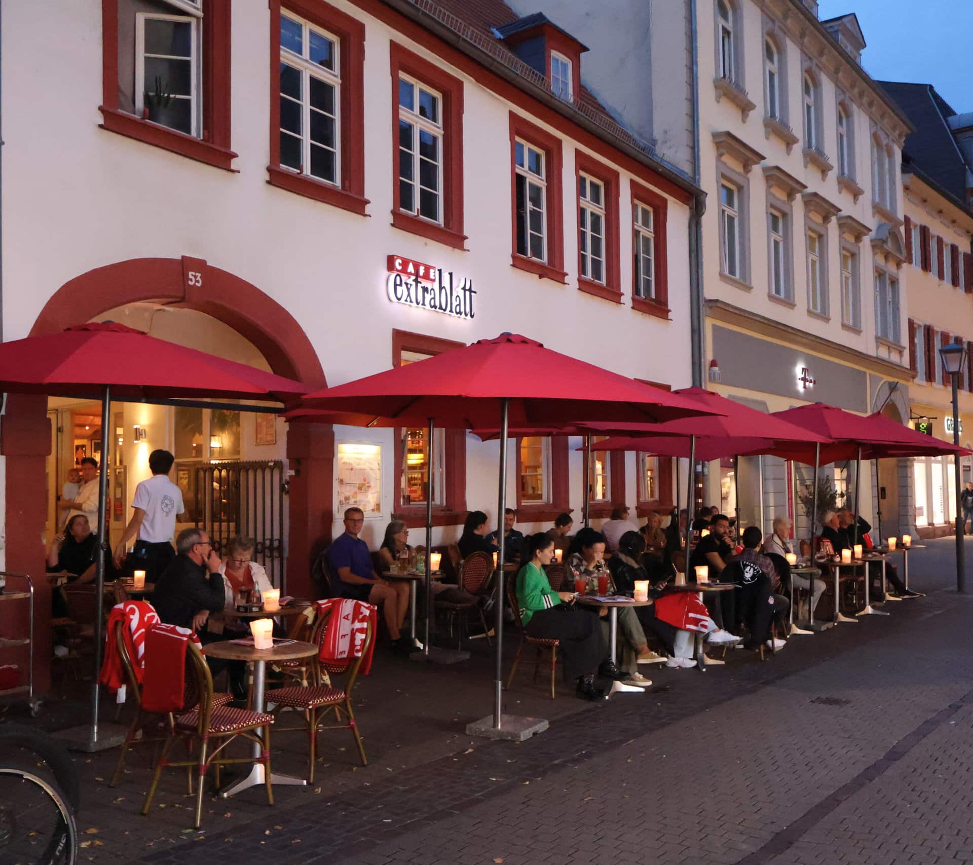 Restaurant with bistro tables and chairs outside in the dark